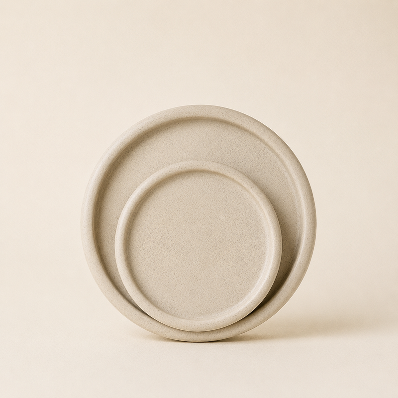 Two stacked speckled cream stoneware plates with raised rims