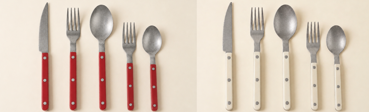 Red and cream riveted flatware sets arranged on a light background