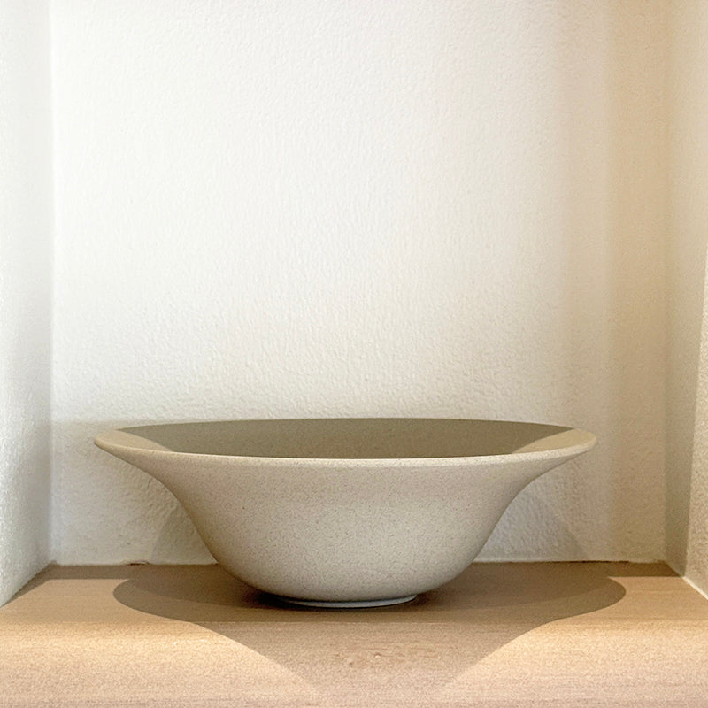 Fisherman bowl on wooden shelf with warm light