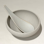 Spoon resting inside bowl top view