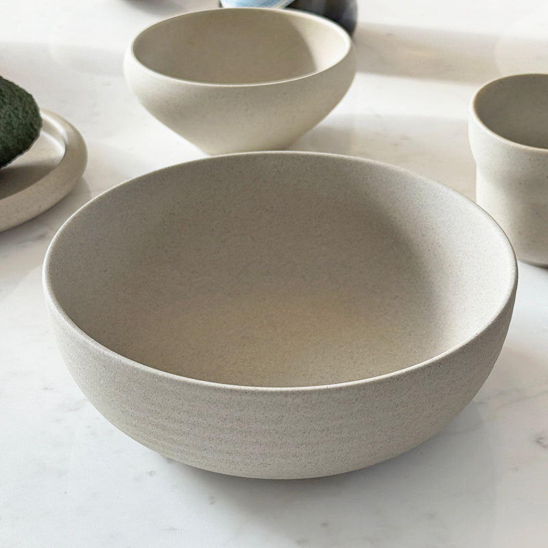 Ribbed breakfast bowl on marble counter with collection