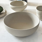 Ribbed breakfast bowl on marble counter with collection