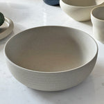 Ribbed breakfast bowl on marble with cup and plate