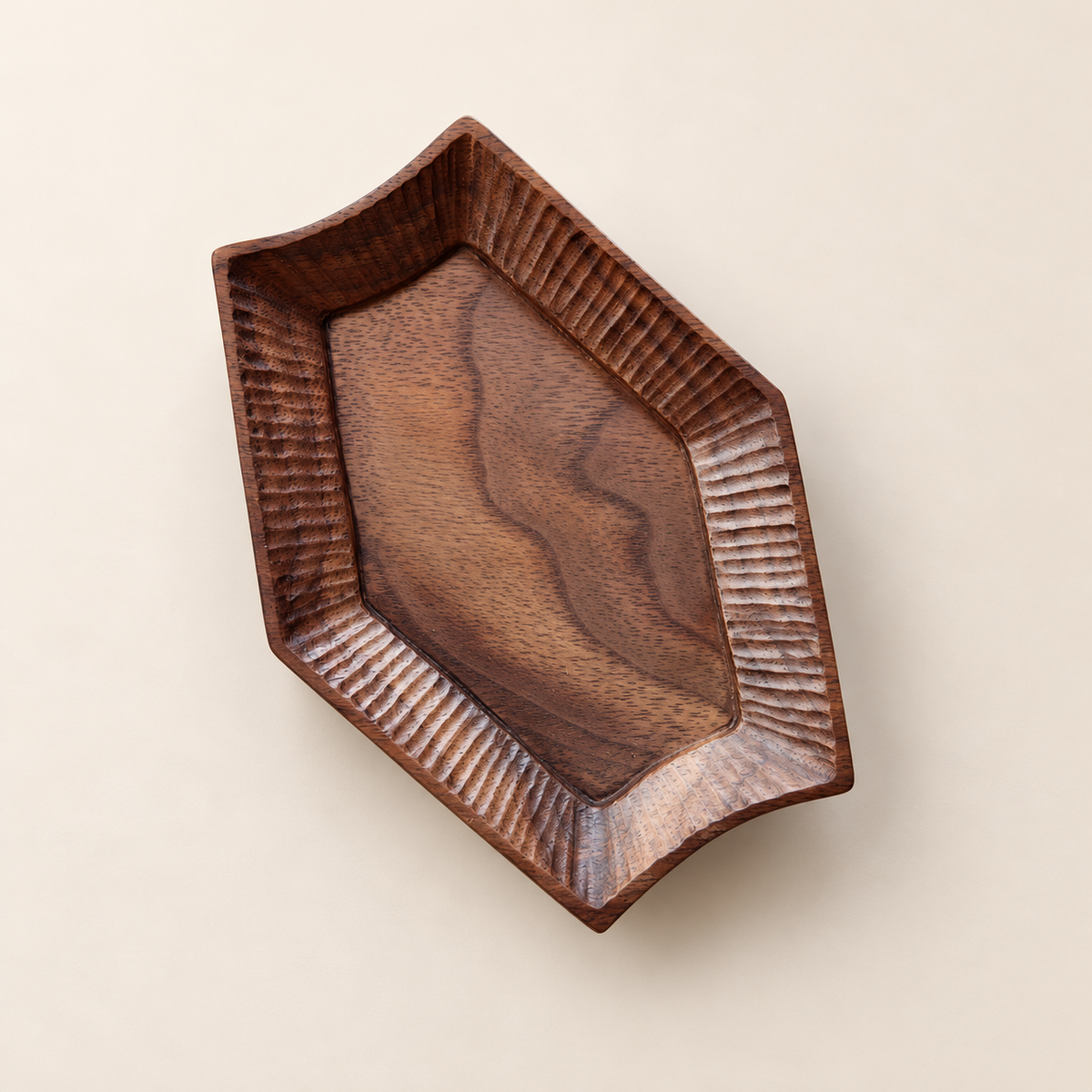 Small black walnut wood dish with carved rim, 13 by 10 cm