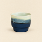 Blue 170 ml handleless ceramic coffee cup with a navy base and pale celadon rim