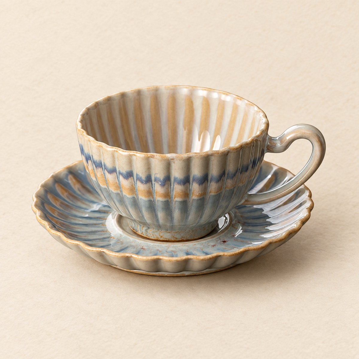Blue grey, cream and ochre glaze detail on fluted cup and saucer