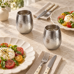 Two Pebble titanium cups with ivory plates and riveted flatware
