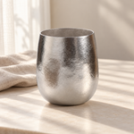 Pebble silver titanium cup in soft window light with linen