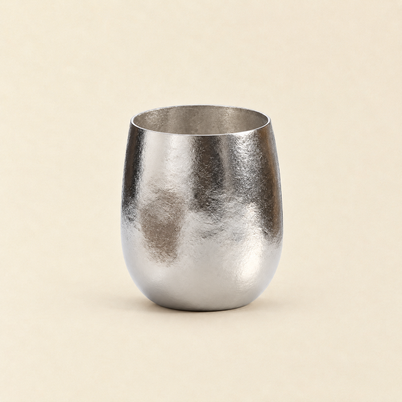 Sundayware Pebble 280ml titanium cup with ice-flower texture on a warm cream background