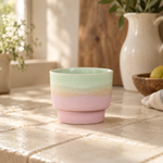 Pink gradient glaze ceramic coffee cup in a kitchen setting